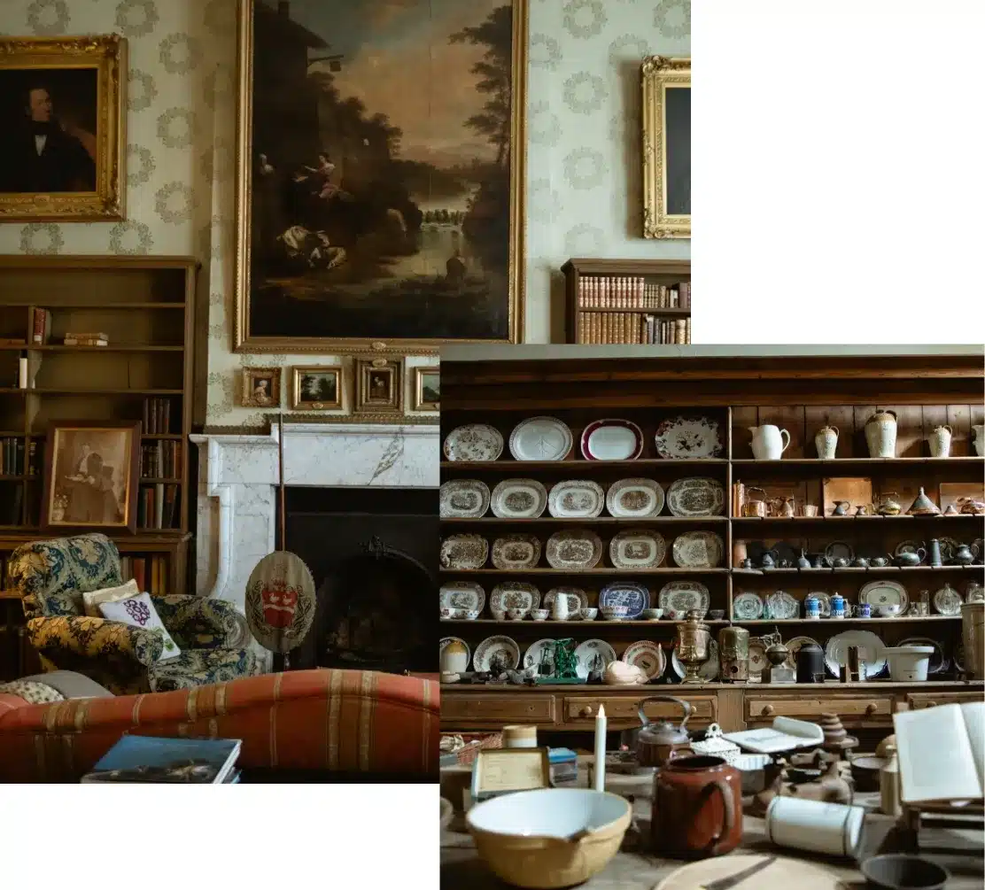 A cozy room with an ornate fireplace, vintage furniture, and art-filled walls. Shelves display an array of colorful plates, bowls, and pottery, adding a charming, eclectic touch to the space.